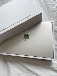 an apple box opened on top of a white sheet