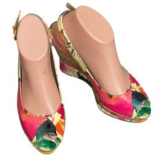 a pair of women's shoes with colorful flowers on them