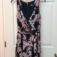 Navy Blue With Pink And White Flower Tommy Hilfiger Dress. Size 6. Dress Has A V/Faux Wrap Style Neckline, Slight Hi-Lo Style Bottom, With A Tie At The Waist. Brand New With Tags, Never Worn. Originally Paid $129. Nonsmoking Household Summer A-line Tommy Hilfiger Dress, Tommy Hilfiger A-line Summer Dresses, Blue Sleeveless Tommy Hilfiger Dress, Tommy Hilfiger Blue Sleeveless Dress, Tommy Hilfiger Pink Spring Dresses, Cream Midi Dress, High Low Maxi Dress, Tommy Hilfiger Dresses, Tommy Hilfiger Dress