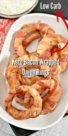 keto bacon wrapped onion rings on a white plate with the text low carb keto bacon wrapped onion rings