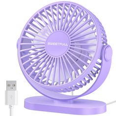 a purple fan sitting on top of a table next to a charger