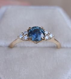 SKY BLUE MONTANA SAPPHIRE RING Once upon a time, the ancient Persians thought sapphires were so special, they believed that the earth had been created on top of the biggest blue sapphire ever, and that's why the sky was blue... It gives so romantic meaning for a blue sapphire engagement ring. One one represents a blue sapphire rig with diamonds to her or his beloved, it's considered representative of sincerity and faithfulness. This nature inspired floral design engagements ring features magic t Heirloom Blue Sapphire Diamond Ring, Blue Sapphire Ring In 14k Gold, Blue Sapphire Ring In 14k Gold For Anniversary, Anniversary Blue Sapphire Ring In 14k Gold, Timeless Blue Sapphire Ring, 14k Gold Blue Sapphire Ring With Center Stone, Heirloom Blue Sapphire Ring With Center Stone, Celestial Blue Rings With Accent Stones, Blue Celestial Rings With Accent Stones