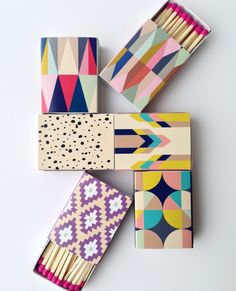 four matchesticks in different patterns and shapes on a white surface with polka dots