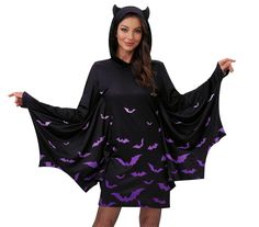 a woman dressed in a bat costume with her hands out to the side while wearing a black and purple dress