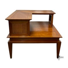 a wooden table with a wicker basket on it's top and bottom shelf