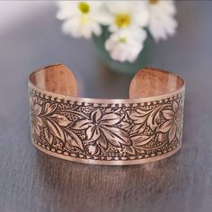 COPPER Bracelet, Copper Jewelry, Solid COPPER Cuff, Embossed Daisy Design, Copper Cuff Bracelet, Copper Cuff Bracelet, Embossed Copper Cuff □ Antiqued Copper Cuff - 1 Piece □ Width: 1 inch wide □ Length: 6.5 inches - adjustable □ Embossed Daisy Design SOLID COPPER, not plated Stunning detail on these beautiful embossed cuffs. These are very sturdy but adjustable The tooling dates back to the 1940s and cannot be duplicated in today's market. Stamped 'solid copper' on the inside. Unlike my raw cuff collection, these special pieces are hand antiqued, hand polished and have a baked lacquer coating for a long lasting look and durability. They have a beautiful embossed daisy design on a solid copper adjustable cuff bracelet and are proudly Made in the USA. To keep the beautiful lacquer finish & Daisy Design, Copper Cuff Bracelet, Copper Cuff, Copper Bracelet, Pure Copper, Copper Jewelry, Antique Copper, Beautiful Bracelet, Cuff Bracelet