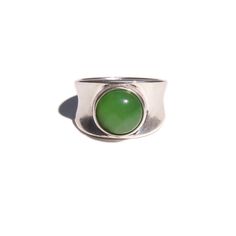 Coco's introduction to rings. The Devon has a Nephrite Jade stone set in solid .925 Sterling Silver.   Wear it by itself or stacked with your favorite jewelry.  Available in sizes 5, 6, 7, and 8 .925 Sterling Silver, Nephrite Jade   Experience the craftsmanship of our jewelry, meticulously handcrafted using rare and delicate materials sourced from around the world. To maintain the quality and beauty of your jewelry, we recommend avoiding contact with water, perfumes, or harsh chemicals. Simply use a microfiber cloth to clean your jewelry and store it in a cool, dry, and dark place. Silver Jade Jewelry In Oval Shape, Silver Jade Gemstone Rings, Oval Cabochon Jade Rings With Polished Finish, Antique Silver Jade Ring, Silver Jade Cabochon Necklace, Nephrite Jade, Jade Ring, August Birthstone Jewelry, July Birthstone Jewelry