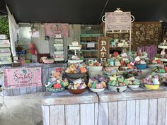 many bowls are stacked on top of each other in front of a sign that says bake sale