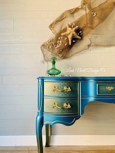 a blue desk with gold accents and a star decoration on top