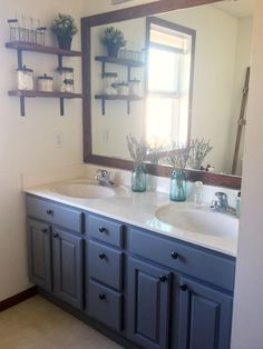 a bathroom with two sinks and a large mirror over it's counter top area