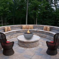 an outdoor seating area with two chairs and a potted plant