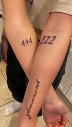 two people holding hands with tattoos on their arms that say 422 and 422