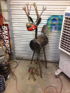 the metal reindeer is next to an air conditioner