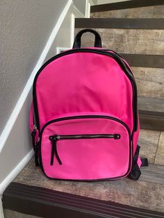 "Large Pink Backpack A cute and trendy backpack, perfect for back to school! Colorful prints highlight this must-have double compartment backpack. Spacious with a built-in, padded sleeve for your laptop, this backpack is great for everyday activities to the office or the classroom. Medium sized bag; 11-3/4?W x 15?H x 6?D (width is measured across the bottom of handbag) Top handle with 2? drop; adjustable shoulder straps with 11? drop Dual compartments with zip closures Silver-tone hardware; two Trendy Backpacks, Medium Sized Bags, Pink Letter, Pink Books, Everyday Activities, Pink Backpack, Monogram Styles, Girl Backpacks, Backpack Purse