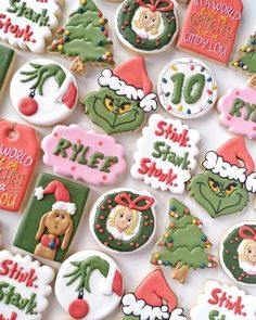 decorated christmas cookies are displayed on a white tablecloth with holiday sayings and decorations