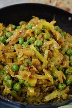 a bowl filled with peas and onions on top of a table