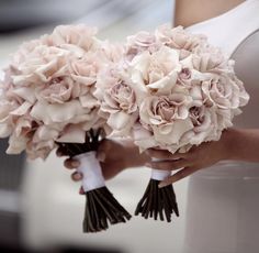 a woman holding a bouquet of flowers in her hands