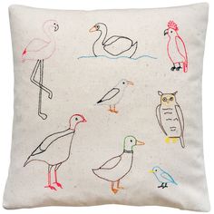 an embroidered pillow with birds on it