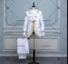 a mannequin dressed in white and gold clothing