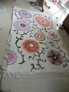 a white rug with colorful flowers on it