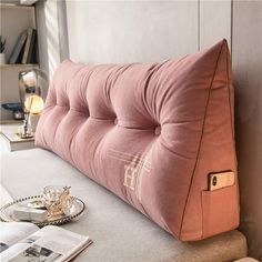 a pink pillow sitting on top of a table