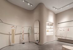 the interior of a clothing store with several mannequins on display in it