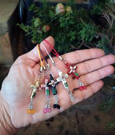 a person holding several small charms in their hand