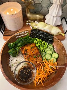 a wooden bowl filled with different types of food