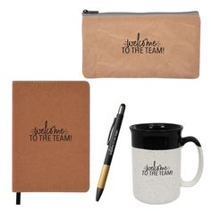 a notebook, pen and coffee mug with the words welcome to the team on it