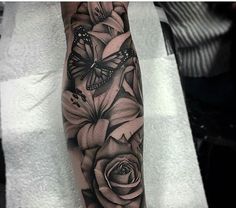 a black and white rose with butterflies on it's leg, done by person