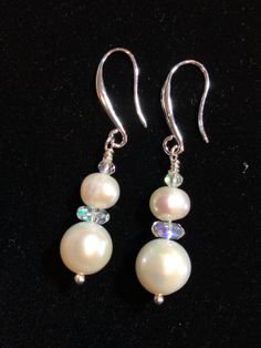 Elegant, great for wedding, Freshwater Pearls and Iridescent Crystals dangle from sterling silver ear wires.  All freshwater pearls have unique markings, shape  and color. I have beautifully matched this set for the perfect pair. They are more white than ivory and have some tinges of pink. (See photo against white) Iridescent crystals catch the light and color to add just the right amount of bling!   These have a casual elegance that can go from wedding day to your blue jean Mondays. Elegant Handmade Iridescent Earrings, Elegant Iridescent Jewelry For Pierced Ears, Iridescent Pearl Drop Dangle Earrings, Elegant Iridescent Nickel-free Earrings, Elegant Iridescent Drop Jewelry, Elegant Iridescent Round Jewelry, Elegant Round Iridescent Jewelry, Elegant Iridescent Jewelry With Pearl Charm, Iridescent Teardrop Earrings For Wedding