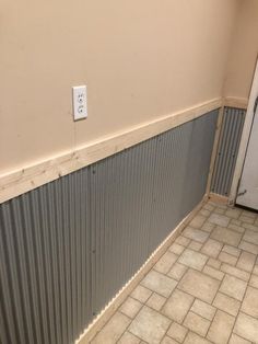 an empty room with tile flooring and a door on the wall next to it