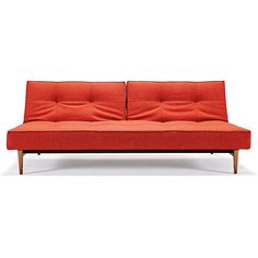 an orange couch with two pillows on it