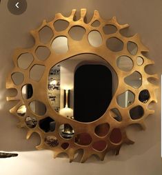 a mirror that is on the wall with holes in it and some mirrors behind it