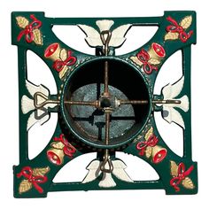 a green clock with red and gold designs on it