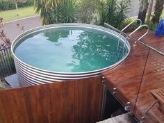 an outdoor hot tub in the middle of a wooden deck