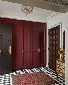 a room with red cabinets and a rug on the floor