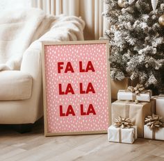 a sign that says fa la la la next to presents