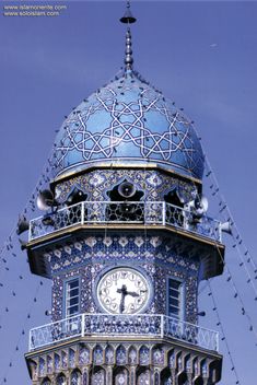 a large blue clock tower on top of a building with lots of lights hanging from it's sides