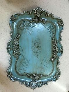 an ornate metal tray with decorative designs on it