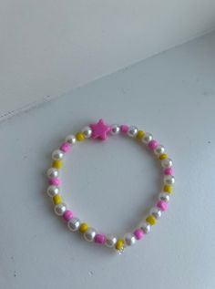 The Starburst Bracelet is a preppy, cute bracelet made with a pop of color! Its stunning pearls and colorful seed beads accented with a preppy pink star stand out alongside any outfit! Purchase this bracelet to add a colorful burst to your wardrobe! Every bracelet comes in 4 different sizes to choose from ensuring that it fits perfectly on your wrist. Trendy Pink Star Bracelet, Pink Star-shaped Beaded Bracelets, Pink Star-shaped Friendship Bracelets, Cute Pink Star-shaped Bracelets, Casual Pink Beaded Pearl Bracelet, Pink Beaded Bracelets With Star Charm, Trendy Pink Bracelets With Star Charm, Pink Star-shaped Jewelry With Colorful Beads, Trendy Pink Pearl Bracelet With Letter Beads