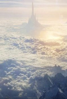 an aerial view of a castle in the sky with clouds and sun shining through it