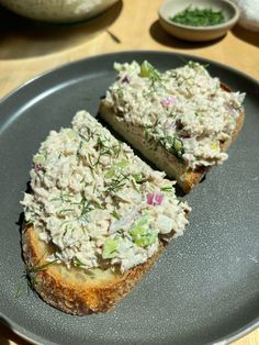 two pieces of bread with tuna salad on them