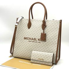 Brand New With Tag Michael Kors Mk Mirella Largew Ew Tote Bag Crafted From Durable Canvas In A Structured Silhouette, Our Mirella Tote Features Gradient Stripes And A Heart-Shaped Mk Charm. With Smooth Leather Accents And A Roomy Interior, This Bag Will Be Your New Daytime Go-To. Wear It With Denim And A Classic White Shirt. Details Color: Vanilla Tote Bag In Gold-Tone Hardware 15.75”W X 14”H X 6.5”D Handle Drop: 4.5” Adjustable Strap: 15”-25” Interior Details: Back Zip Pocket, Front Slip Pocket Luxury Beige Wallet, Michael Kors White Bag With Detachable Handle, White Michael Kors Bag With Detachable Handle, Michael Kors Beige Rectangular Wallet, Michael Kors Luxury Beige Wallet, Luxury Beige Michael Kors Wallet, Michael Kors White Bag For On-the-go, Designer White Travel Wallet, Luxury White Wallet For Travel