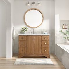 a bathroom with a sink, mirror and bathtub