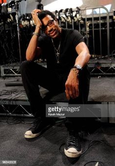 a man sitting on the floor in front of microphones