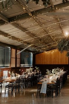 an indoor venue with tables and chairs covered in lights