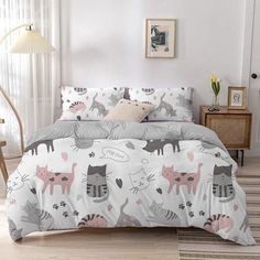 a bed with pink and black cats on it