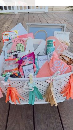 a white basket filled with lots of items on top of a wooden floor next to a building