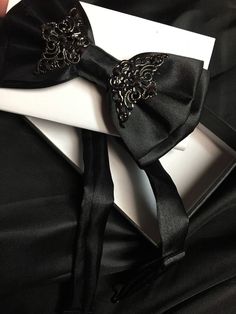 Black satin bow tie with adjustable strap. So amazing! Much better than a regular boring bow tie. Black Satin Tuxedo For Formal Occasions, Elegant Satin Tuxedo For Party, Black Satin Tuxedo For Formal Events, Black Bow With Tie Back As Gift, Satin Bow Ties For Parties, Dapper Black Suit And Tie Accessories With Decorative Bow, Black Tuxedo With Bow Tie For Black Tie Occasion, Black Tuxedo With Bow Tie For Black Tie Events, Party Satin Ties With Decorative Bow